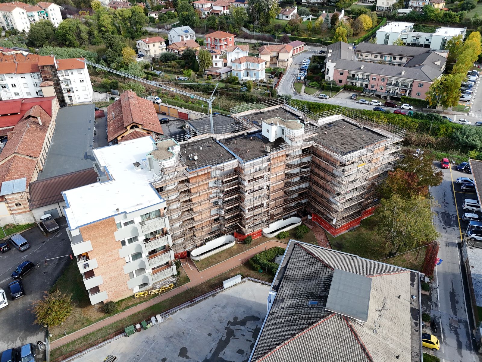 Aerial view of an apartment building wrapped in scaffolding